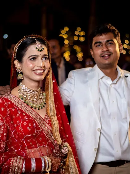A candid moment of the couple with a family member, sharing a happy smile. We believe in capturing the joy of the entire family on the wedding day.
