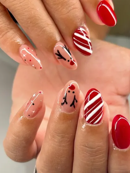 Another look at this adorable hand-painted reindeer and candy cane Christmas manicure.