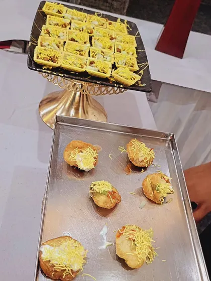 A tray of freshly prepared dahi puri and sev puri, ready to be served. These classic chaat items are a must-have for many parties and gatherings.