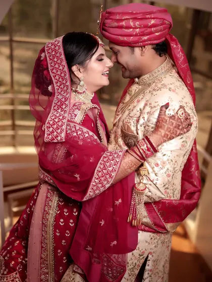 A candid and joyful portrait of a newly married couple. Their happy smiles and comfortable embrace on the staircase capture the excitement of the moment.