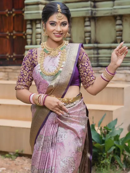 A confident pose showcasing the intricate blouse work and how it pairs with the necklace set.