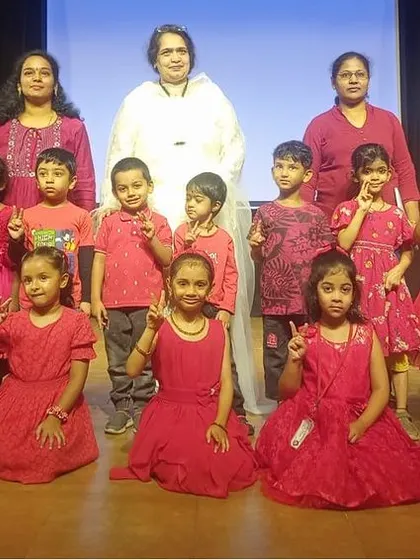 Another group of performers in red, celebrating the successful conclusion of their summer camp.