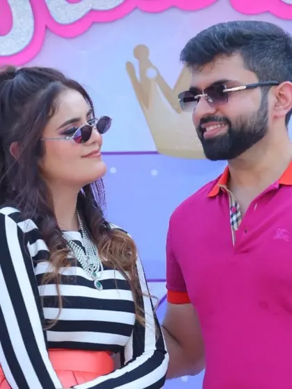 Capturing the candid moments between guests at a kid's birthday party. The stylish couple shares a laugh, showing that these events are fun for the adults too.