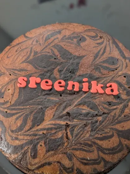 Here is a chocolate marble cake, where I swirl rich chocolate batter into the classic vanilla-jaggery base. I can personalize it with a name, like this one for Sreenika, making it a lovely custom cake for any occasion.