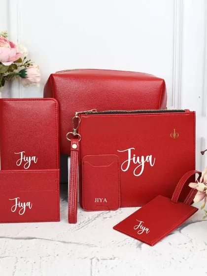 This vibrant red travel kit ensures a seamless and organized journey. The matching set includes a personalized pouch, passport cover, card holder, and luggage tag.
