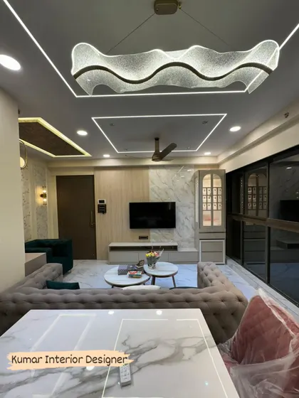 A view from the dining area of the completed project, showing the stunning wave-form chandelier and the overall luxurious feel of the space.
