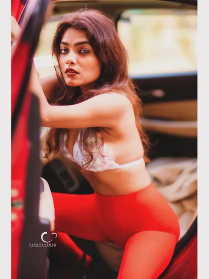 A dynamic and alluring pose, as if stepping out of the car. The composition is full of energy and a sense of daring confidence.