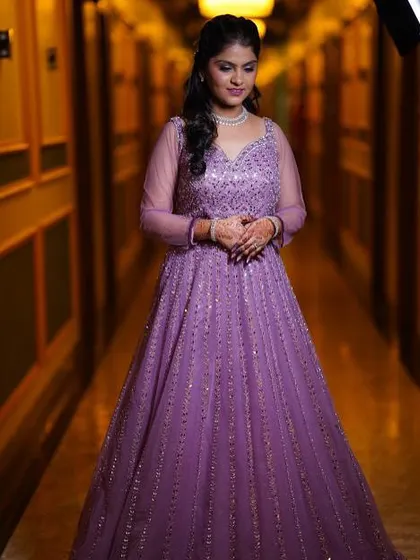 A full-length view of the bride in her gorgeous purple gown, showing how the makeup and hair complete the entire look.