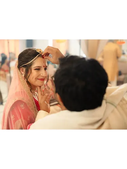 The groom applying the sindoor, a poignant and symbolic ritual that we capture with intimacy and respect.
