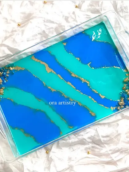 A top-down view of the blue and teal serving tray, showing the beautiful abstract patterns and geode corners.