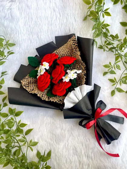 A full shot of the red rose bouquet in its black wrapping, tied with a red and black ribbon. This design is popular for its bold and romantic look.