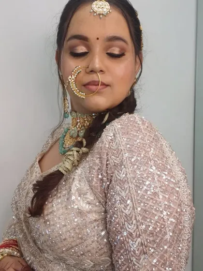 A beautiful shot of the bride's makeup and jewellery, including the traditional nath.