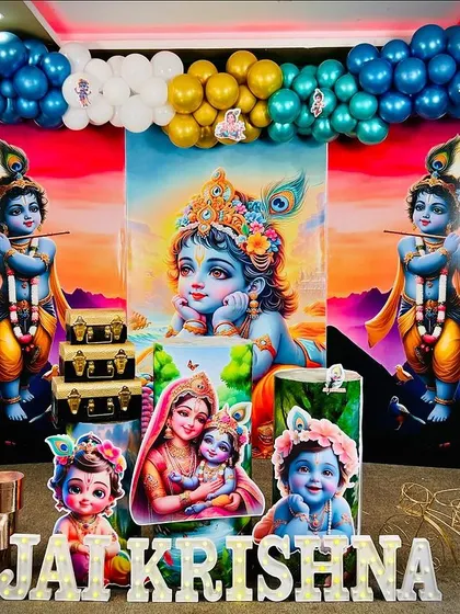Our Krishna theme decoration is vibrant and detailed. This setup includes a beautiful backdrop of Lord Krishna, surrounded by a colorful balloon arch, character cutouts of Krishna and Yashoda, and traditional props to create a divine atmosphere.