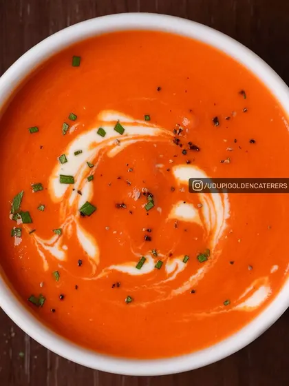 A classic Cream of Tomato soup, rich in flavor and garnished with fresh cream and chives. This timeless soup is a favorite on our catering menu.
