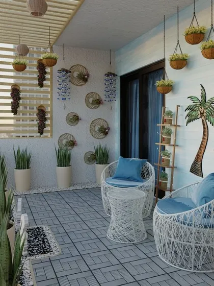 A wider look at the boho balcony, showing the woven white chairs and hanging planters. The design maximizes the small space, creating a stylish and cozy outdoor nook with a view of the city.