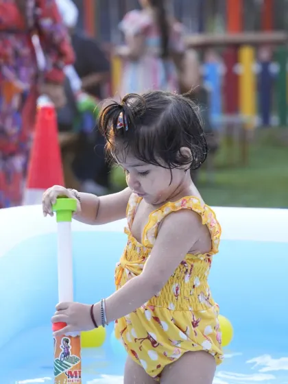 Getting ready for some water fun. A toddler enjoys the splash pool, a safe and refreshing activity for our youngest party guests during the summer months.