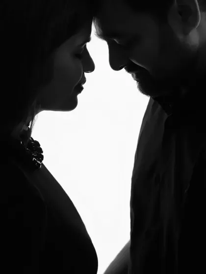 A pure and simple silhouette of a couple. This black and white image captures the intimacy and connection between them in a quiet, artistic way.
