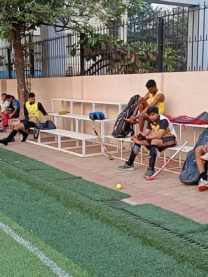 Players take a break on the sidelines, discussing the game and rehydrating. Rest and recovery are just as important as the drills themselves in our training regimen.