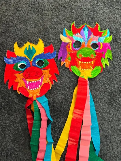 Another pair of beautifully coloured dragon masks, showing the unique creativity of each child.