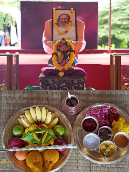 The setup for a Guru Puja, with offerings of fruits and flowers arranged before my portrait. This ritual is a way to honor the Guru principle that resides both outside and within us.