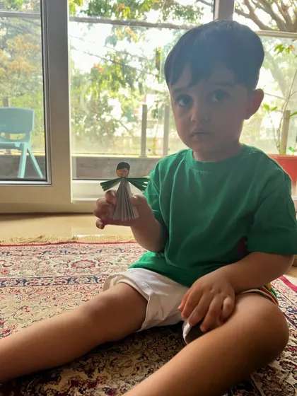 This little man is proudly holding the paper fairy he crafted. Our art sessions are for everyone.