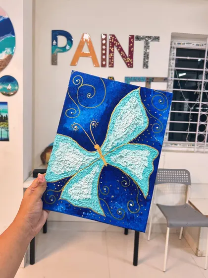 A magical textured butterfly painting on a deep blue canvas, with gold swirl details. This is part of my painting membership program.
