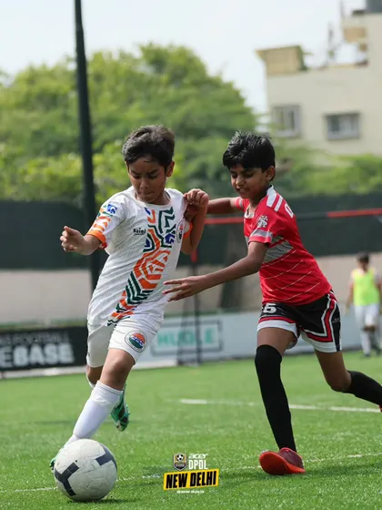 Dribbling past a defender. We teach our players the creative skills and quick thinking needed to beat opponents and create scoring opportunities.