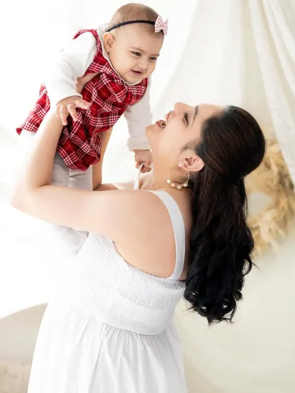 The pure joy of a mother lifting her baby high. We love capturing these playful, interactive moments that show the happy bond between parent and child.