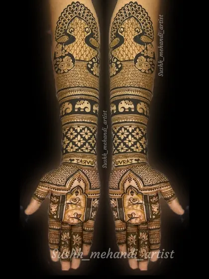 A complete bridal mehandi with the couple's names, Taru and Yuvraj, written on the wrists. The design is filled with peacocks and elephants.