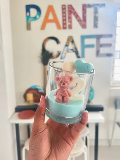 A custom birthday candle, featuring a teddy bear and the number two. I can create personalized candles for any occasion.