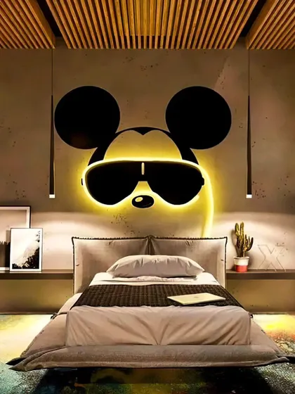 A cool and modern kid's bedroom featuring a backlit Mickey Mouse silhouette as a headboard. The design is minimalist yet playful, creating a stylish space that any Disney fan would love.