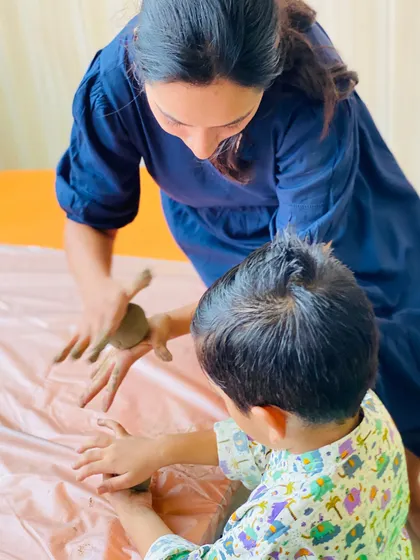 An instructor provides gentle guidance during the Ganesha workshop. We are always on hand to help, ensuring that even the youngest artists can successfully complete their projects.