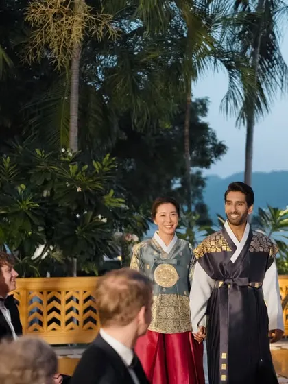 The couple makes their entrance to the Paebaek ceremony, dressed in traditional Korean Hanbok, ready to honor their families in this beautiful fusion wedding.