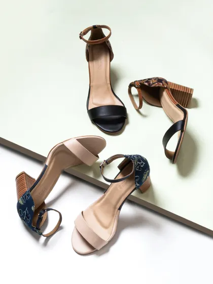 A dynamic and creative composition of heeled sandals. The angled placement and clean background create a modern, architectural look that is more engaging than a standard product shot.