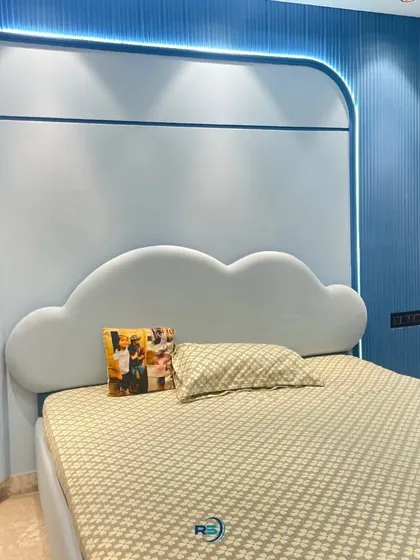 We love creating imaginative spaces for kids. This bedroom features a custom-designed bed with a soft, cloud-shaped headboard and a curved, two-tone wall panel with integrated backlighting to create a dreamy ambiance.