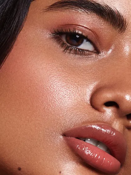 An extreme close-up macro beauty shot. This image highlights incredible detail, from the texture of the skin to the glossy finish on the lips, demonstrating a high level of technical skill in retouching and photography.