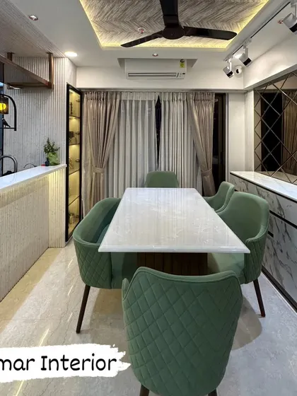 A different angle of the green-themed dining space, showing the bar counter and decorative lighting.