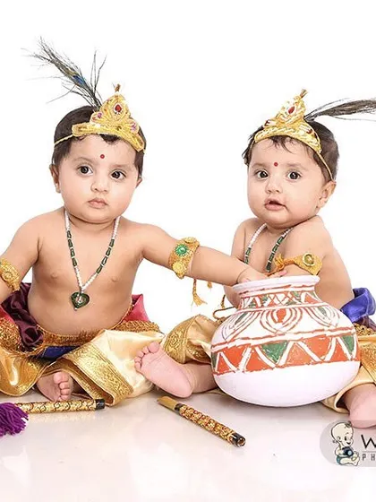 Two little Krishnas are better than one! These adorable twins, dressed in traditional attire with peacock feathers, make for an incredibly cute and memorable festive photoshoot.