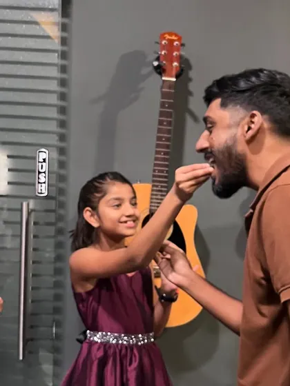 A student shares a celebratory treat with an instructor. We believe in celebrating small wins and creating a family-like atmosphere in our classes.