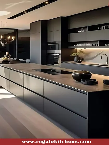 Bold and sophisticated, this all-black island kitchen makes a powerful statement. We used matte black finishes and a solid countertop to create a monolithic, modern look, complemented by subtle under-island lighting for ambiance. This design is for those who appreciate daring, minimalist style.