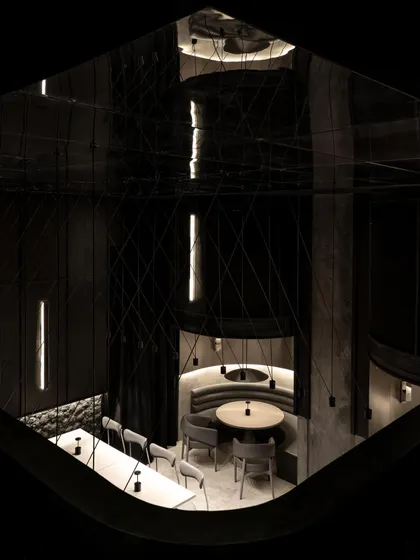 An overhead view of the dining pods at Lair, revealing the geometry of the seating arrangements. The design uses curved forms to create pockets of intimacy within the larger, open space.