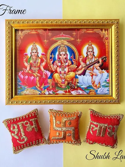 The centerpiece of our Diwali hamper is this beautiful framed picture of Laxmi, Ganesh, and Saraswati, accompanied by handmade shubh labh pillows.