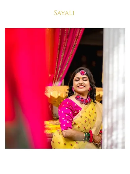 A serene portrait of the bride during her Haldi function, framed with her name for a personalized touch.