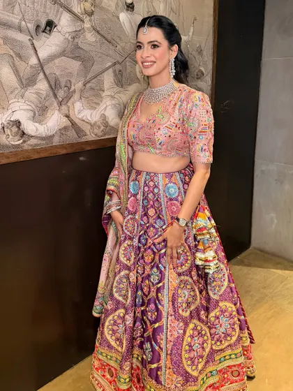 A full view of Priyanka's vibrant party look. The makeup is kept fresh and radiant to complement the colorful Mayyur Girotra lehenga.