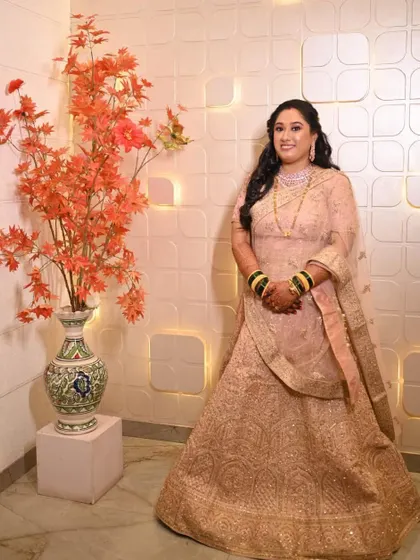 The bride looking absolutely regal in her peach lehenga. The makeup is soft and luminous, letting her intricate outfit and diamond jewellery take center stage.