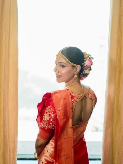 A classic shot of my Maharashtrian bride, showing the beautiful detailing on her blouse and the traditional floral bun. The makeup is kept fresh and radiant to complement the red silk saree.