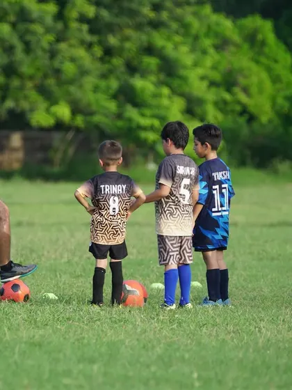 Here I am demonstrating proper technique to our young players. We believe in hands-on coaching, providing clear instructions and individual attention to ensure every player understands the fundamentals of the game.