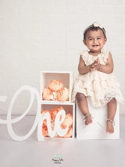 A beautiful and simple setup to celebrate turning one. The clean white background and floral details create an elegant and timeless milestone portrait.