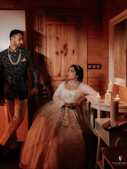 The couple looking at each other in a candlelit, rustic room, a perfect picture of intimacy.