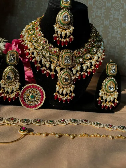 Embrace the quirks of elegance. This is our complete multi-colour Kundan bridal set, including a necklace, earrings, maang tikka, nath, and a statement ring.